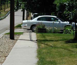 Picture of car obstructing sidewalk